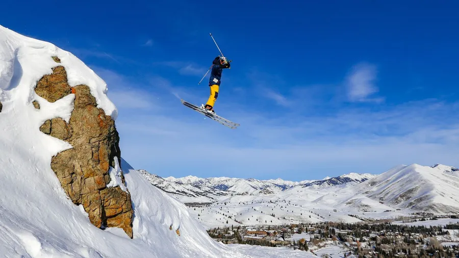 Teenager ski jumping off a cliff at Sun Valley Resort, Idaho.
