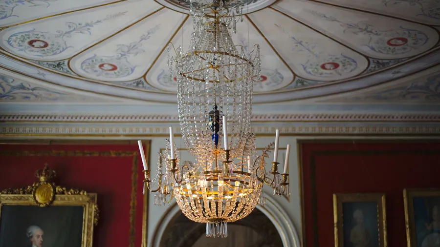 An ornate interior with a chandelier and rich decorations.