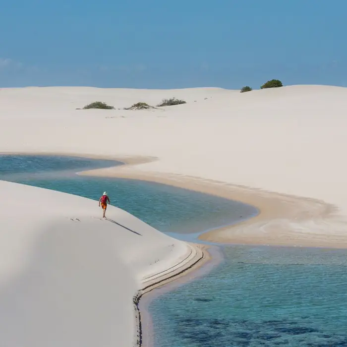 Brazil’s lagoon-filled desert where visitors hike barefoot between dunes
