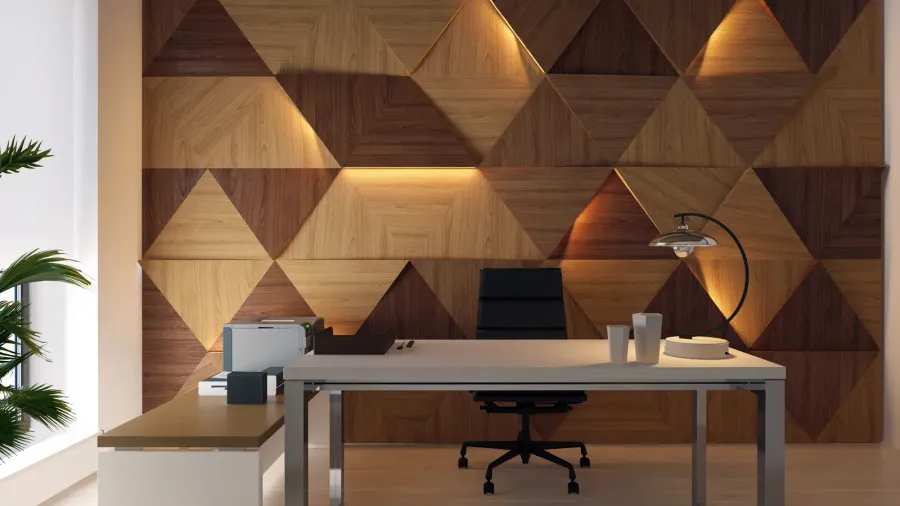A home office interior with a table, lamp, plant, and a chair in front of a 3D wall panel.