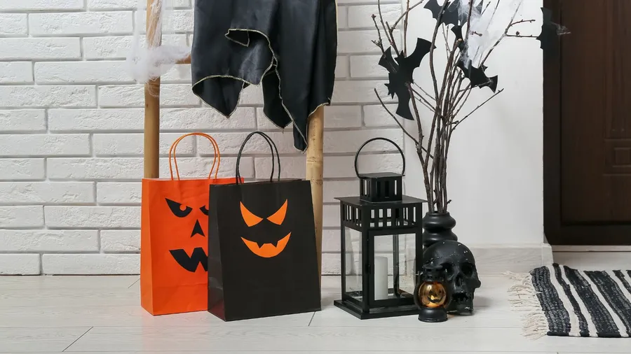 Gift bags with ladder and Halloween decor in hallway