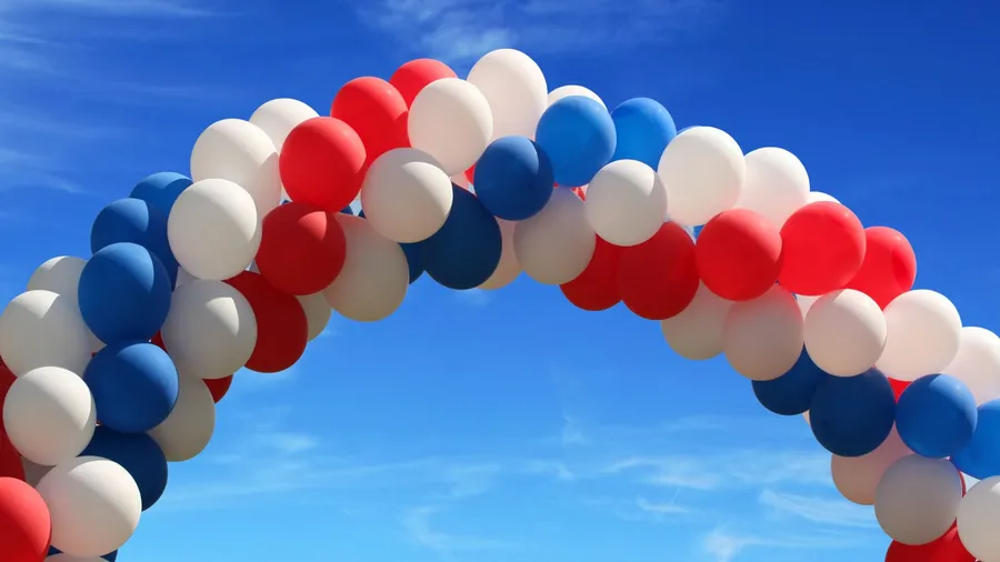 A beautiful balloon arch with red, white, and red balloons on Memorial's Day.
