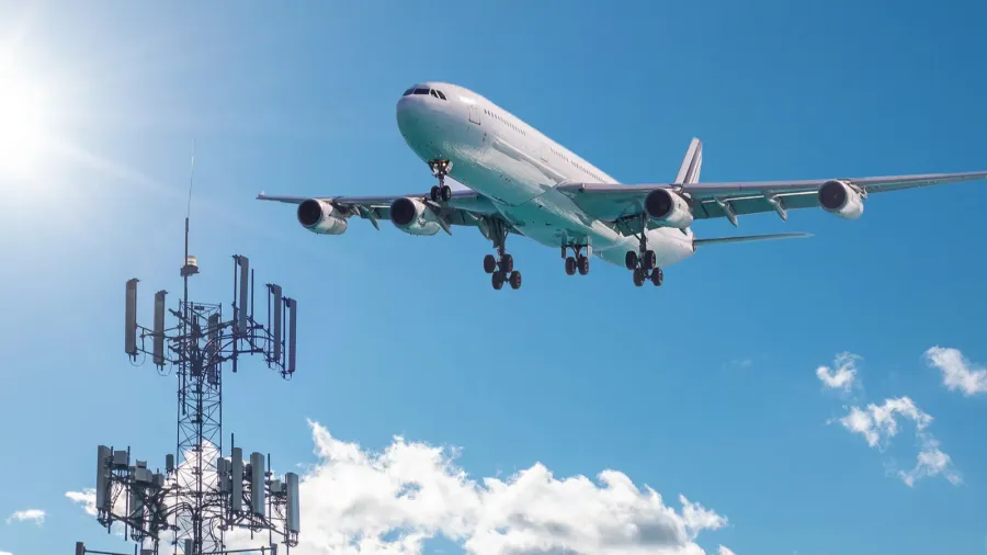 5g cell phone or mobile service tower with aircraft approaching