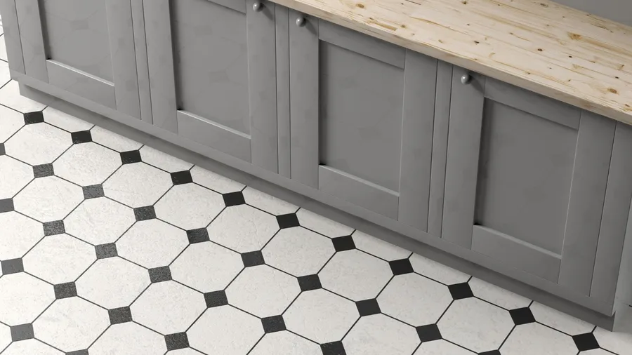 A kitchen interior with wooden countertop, gray cabinets, and geometric pattern black and white tiles.