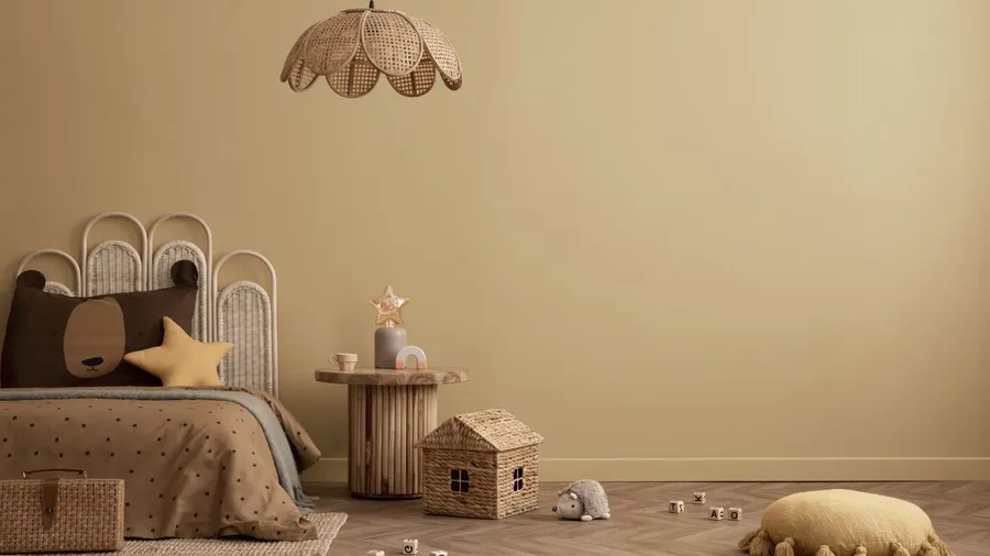 A children's room with a bed decorated like a bear, toys, and a star-shaped pillow.