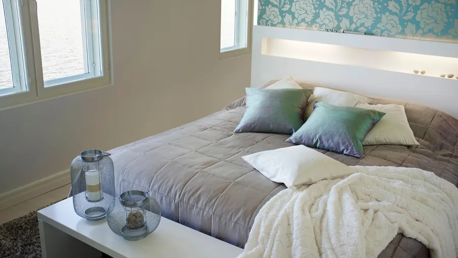 A comfortable bed with soft pillows and a cozy blanket.