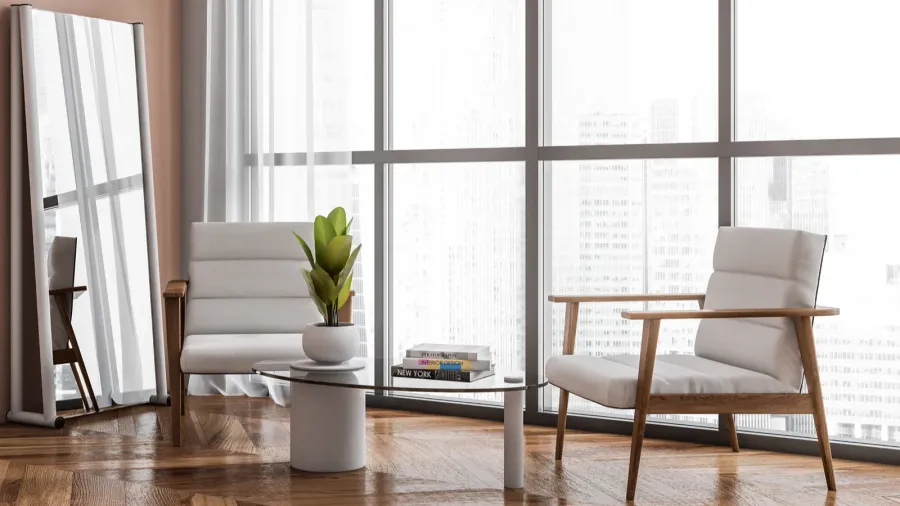Bright waiting room interior with two armchairs, panoramic window with city skyscraper view, oak wooden hardwood floor, coffee table with books.