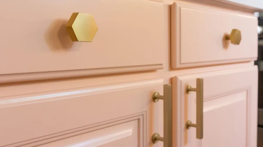pink peach cabinets with gold hardware
