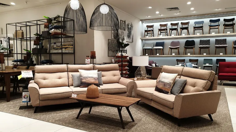 A cozy living room setup with a beige sectional sofa, a coffee table, and decorative pillows.