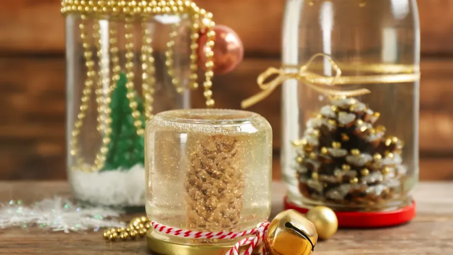 Handmade Christmas snow globes on wooden table