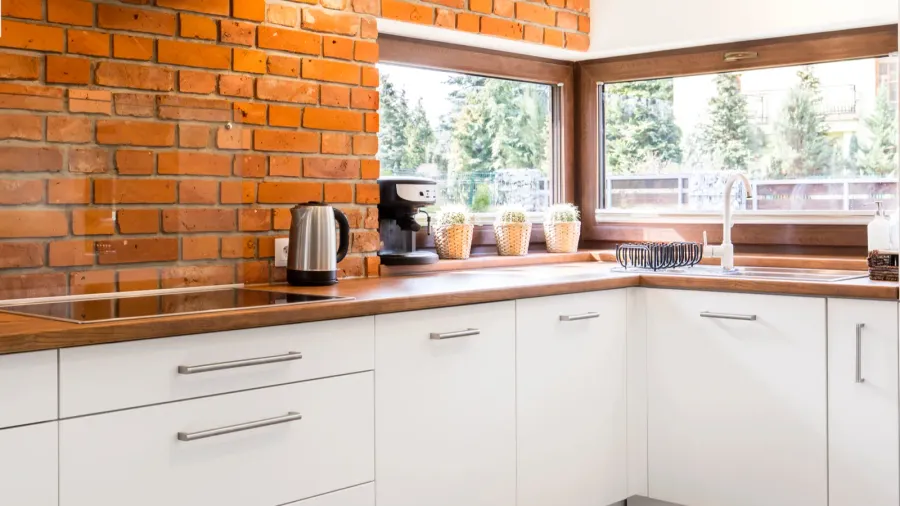 Kitchen with brick wall