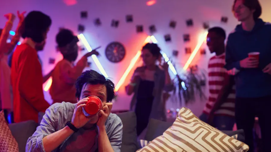 Man drinking beer at party