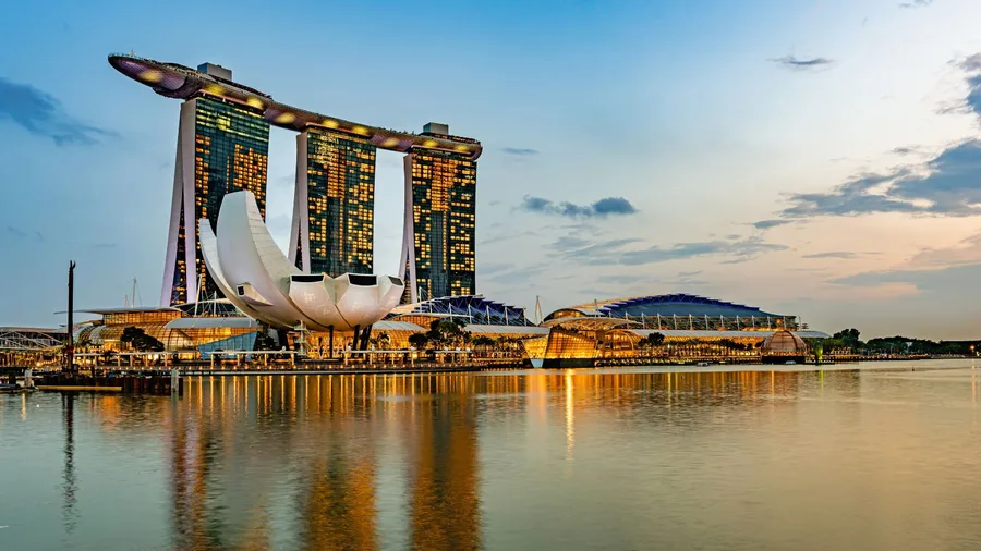 Marina Bay Sands hotel in Singapore reflecting on the water at sunset.