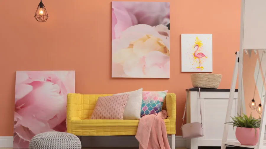 A vibrant room with a soft peach wall features a yellow