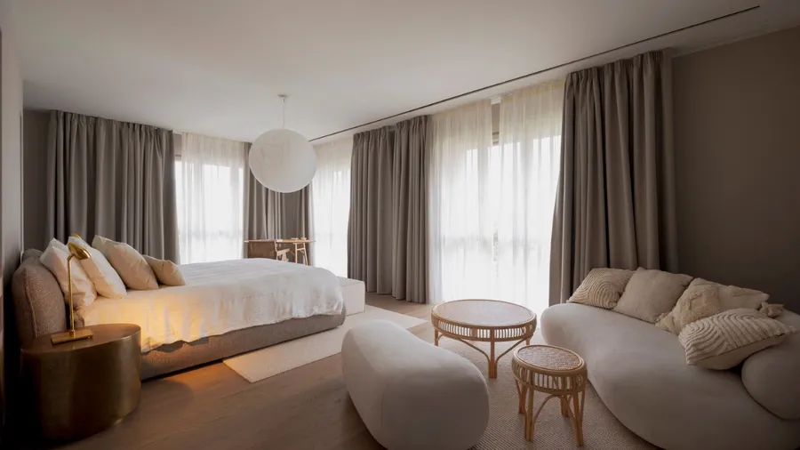 A modern bedroom with soft colors and stylish furniture.