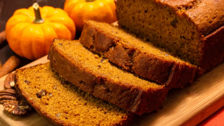 Pumpkin bread on wooden platter.