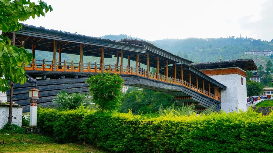 Traditional wooden bridge and structure surrounded by lush greenery at Santani Wellness Resort and Spa in Kandy, Sri Lanka.