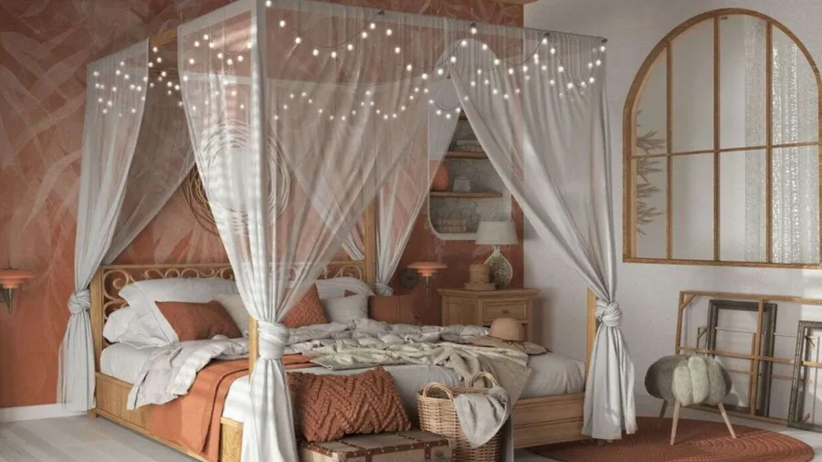 A cozy bed with a canopy and string lights in warm tones.