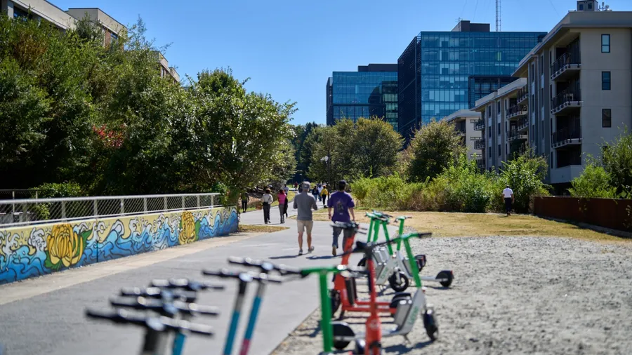 ATLANTA, GEORGIA - OCTOBER 20 2025: Vibrant autumn scene along the Atlanta BeltLine on a sunny October day. People enjoy outdoor activities — walking, jogging, running, and biking.