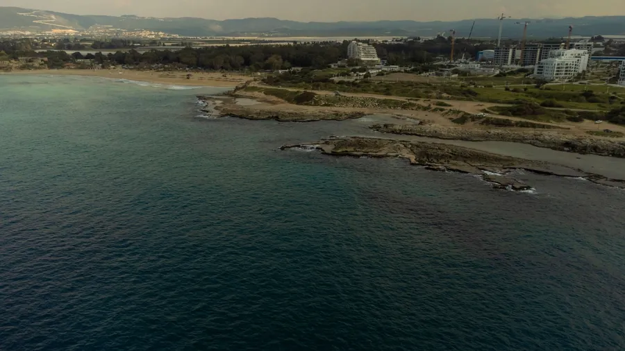 panoramic aerial view of cities of Nahariya on the Mediterranean coast, the endless blue sea and the coastline with waves, a small developing city in north of Israel. Akhziv district near Nahariya