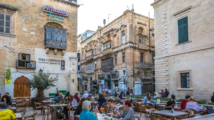 Valletta, Malta - May 22nd 2018 - Tourists having lunch in a open air restaurant inside the old town of Valletta, capital of Malta