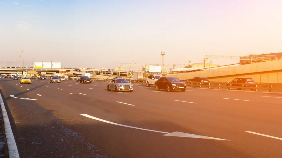 Traffic on a highway with sunlight