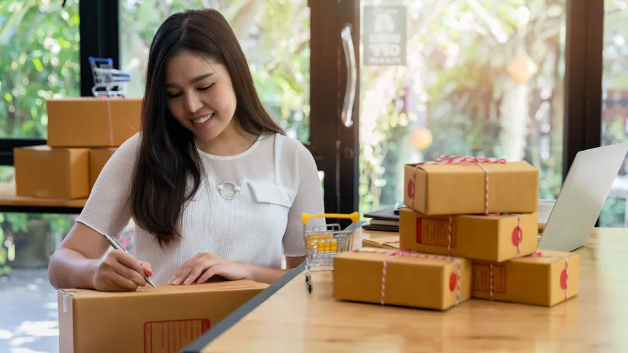 Successful entrepreneur business woman with online sales and Parcel shipping in her home office, prepare parcel box of product for deliver to customer.