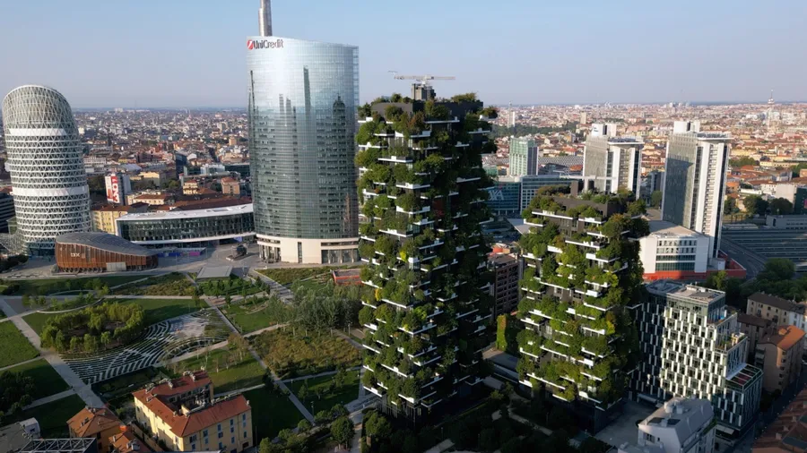 Europe, Italy,Milan 08-18-2023 - drone aerial view of Vertical Forest ( bosco verticale ) luxury skyscraper ecological and sustainable with trees and greenery on the facades in Gae Aulenti new skyline