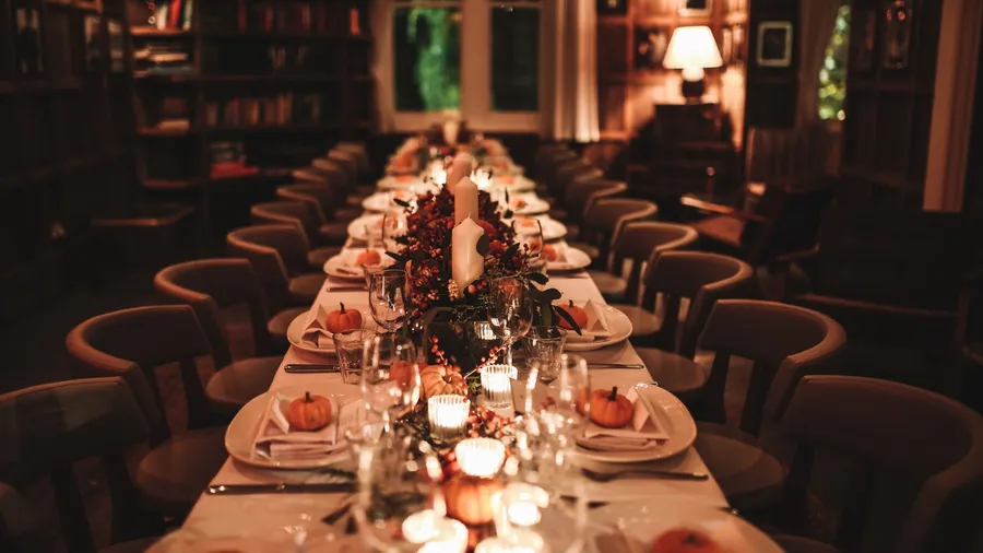 A beautiful table setting for Thanksgiving dinner in a restaurant. Private dining. Horizontal image, indoors, selective focus.