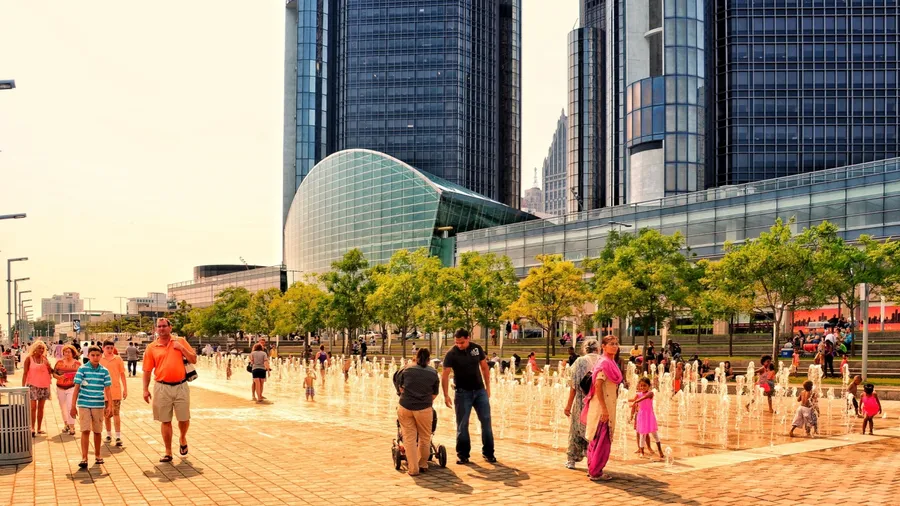 Detroit, Michigan, US- July 4, 2015: Detroit downtown riverside. People enjoying a sunny summer day on the America Independent holiday and celebration. Beautiful cityscape - Detroit RiverWalk
