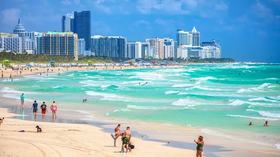 Miami Beach, Florida, USA, March 30 2022: Miami Beach colorful beach and ocean view, Florida state, United States of America. People enjoying winter beach.