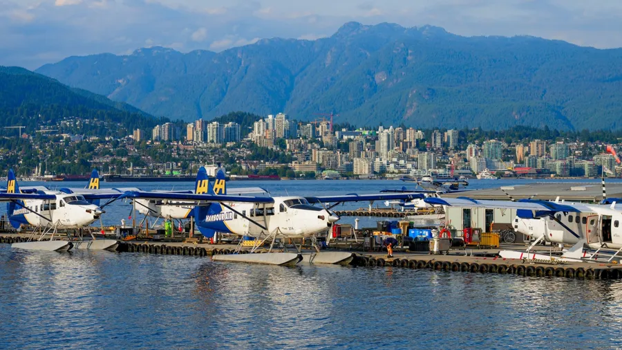 Vancouver, Canada - Aug 8, 2023 : Lineup of seaplanes in Vancouver Harbour Flight Centre - Seaplane terminal of Vancouver Airport made of pontoons floating in Coal Harbour, British Columbia, Canada