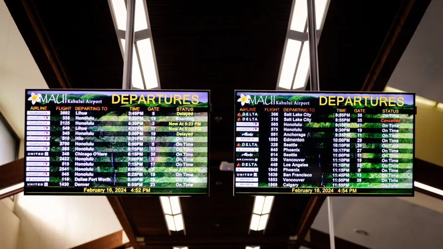 Kahului, Hawaii US - February 16, 2024: Airport flight information on a large screen boards at Kahului Airport (OGG)