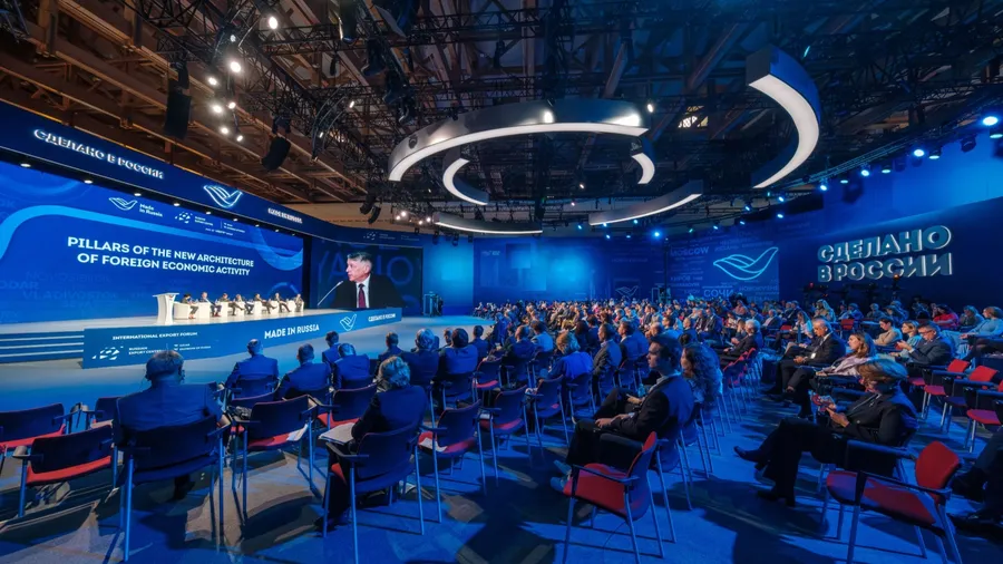 Moscow - October 19, 2023: Businesspeople attending global conference meeting in blue illuminated auditorium at Made in Russia Export Forum