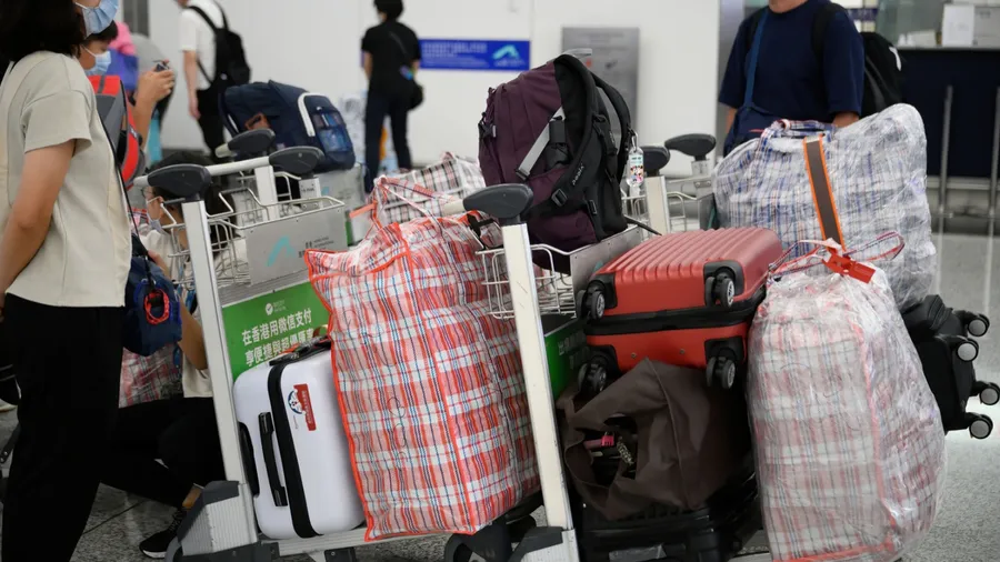 Airport Departures Terminal, HongKong-18July2021: heavy luggage and baggage send to registration center in airport terminal for migration to other countries