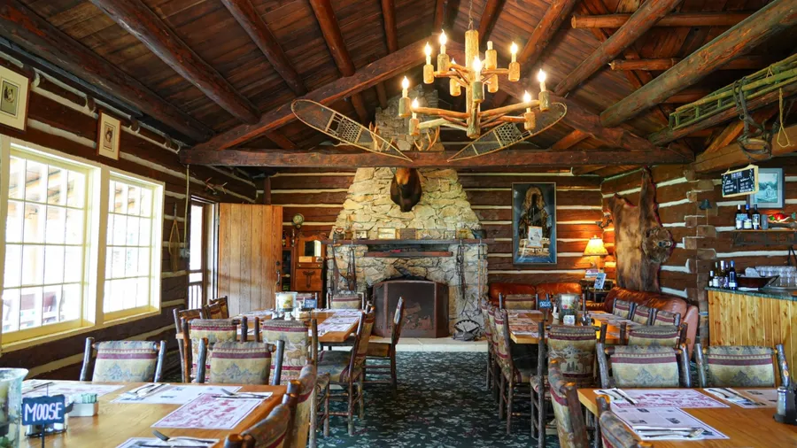 Taku Lodge, Alaska - August 25, 2023 : Dining room of the log house of the Historic Taku Glacier Lodge, a wooden cabin located in the mountains north of the Alaskan capital city Juneau