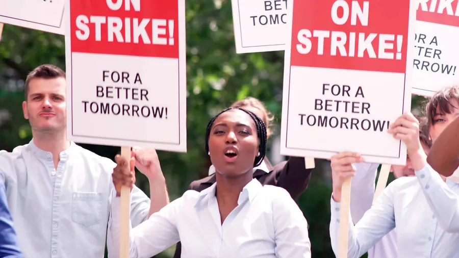 Union workers in city demonstrate power during labor strike.
