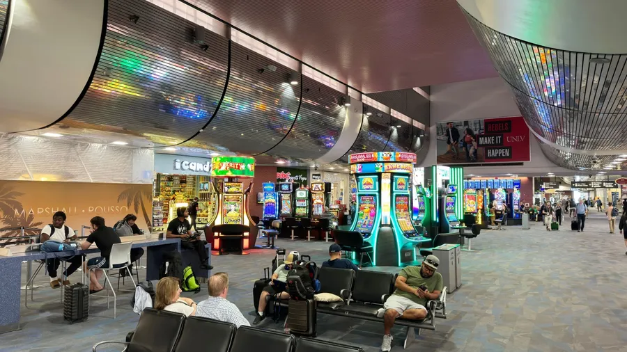 Las Vegas,Nevada,USA-June 11th 2024: travelers and slot machine inside Harry Reid International Airport