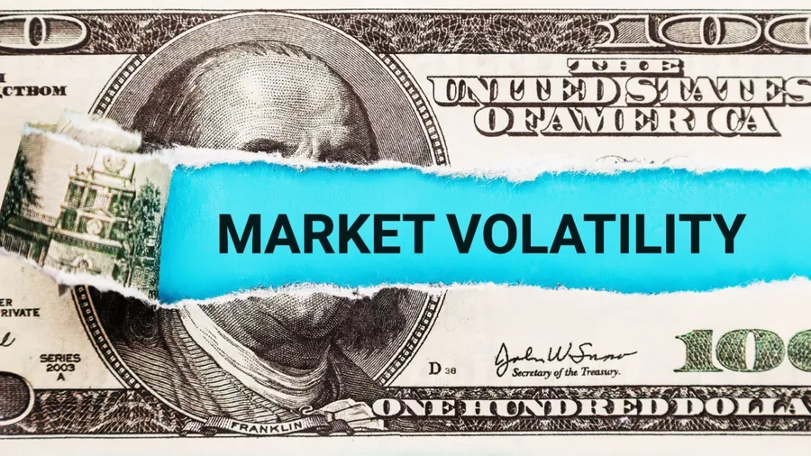 Market Volatility. The word Market Volatility in the background of the US dollar. Financial Market Volatility Concept. Shaky Stock Market Graph, Roller Coaster Ride of Investments and Trading.
