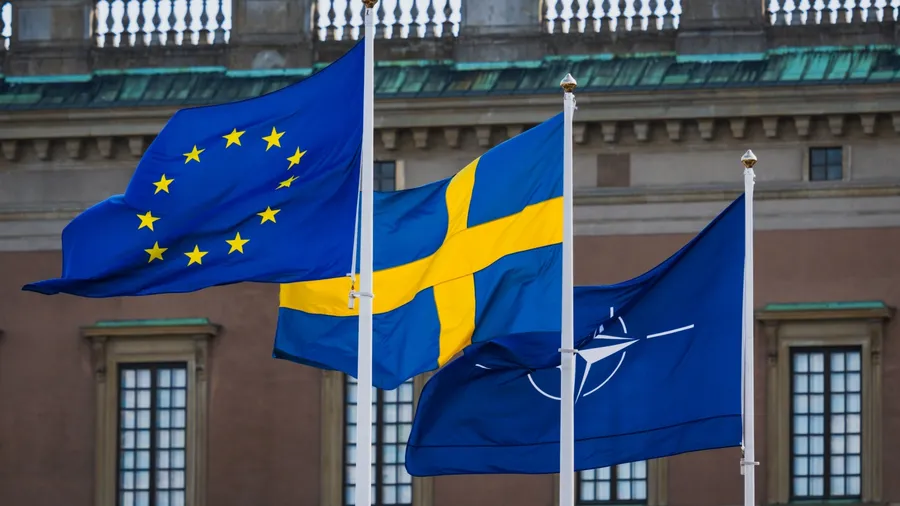 STOCKHOLM, SWEDEN – APRIL 4, 2025: Flags of the European Union, Sweden, and NATO fly together symbolizing alliance memberships.