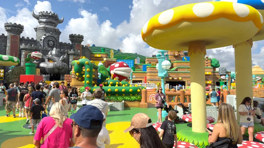 Orlando, Florida – May 2, 2025: Guests queue beneath giant mushrooms at Super Nintendo World in Universal’s Epic Universe for the Mario Kart: Bowser’s Challenge attraction.