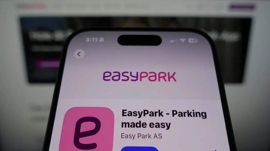 Kiel, SH, Germany March 27 2025: EasyPark by Easy Park AS in the App Store on smartphone screen with company website in background showcasing service offerings.