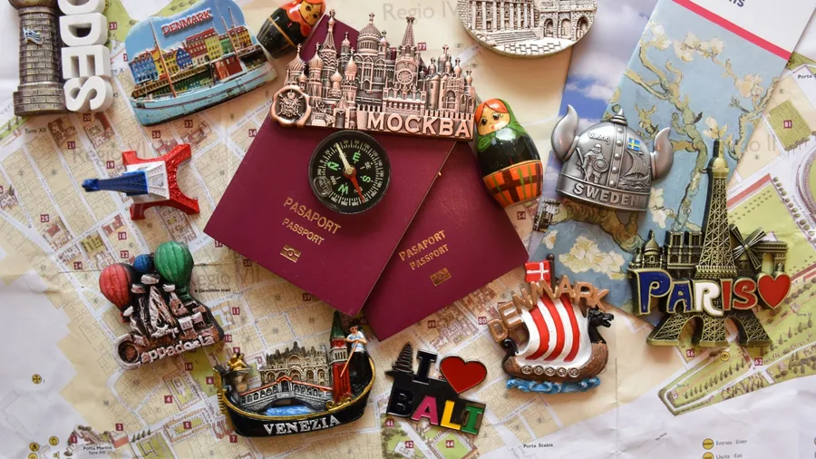 Holiday excitement lots of beautiful memories and colorful souvenirs from the vacation (passports stamps and fridge magnets)