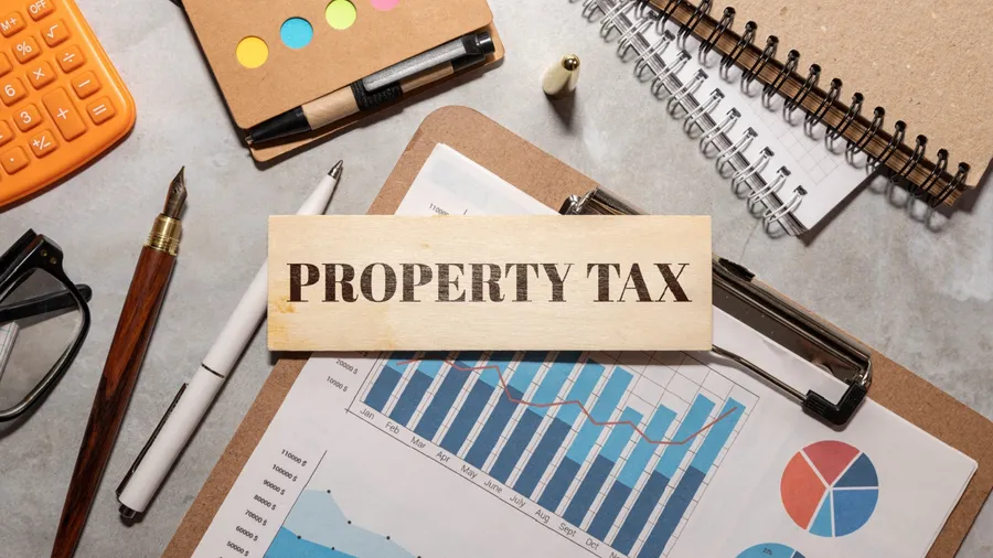 open notepad near a plant in a pot. text Property tax symbol.