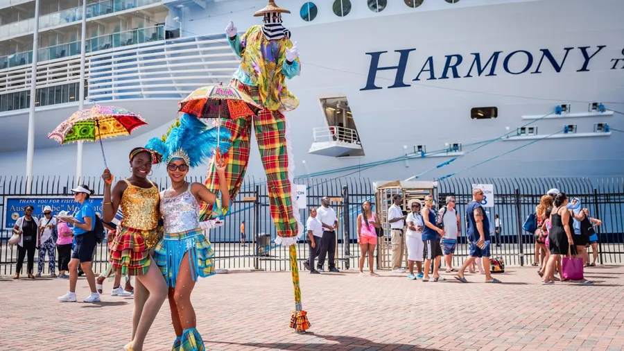 St. Thomas, USVI USA - August 21, 2018: Costumed dancers and a man on stilts great cruise ship passengers at the Crown Bay Marina.