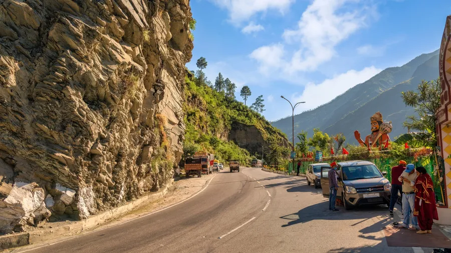 Himachal Pradesh, India, October 24, 2021: Tourist cars on scenic mountain highway road near Hanuman temple on way to Narkanda Himachal Pradesh, India