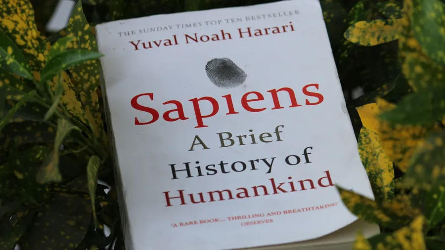 Uttarakhand, India - Feb 26, 2023: Close up of Sapiens: A Brief History of Humankind book by Yuval Noah Harari in a green-yellow leaves