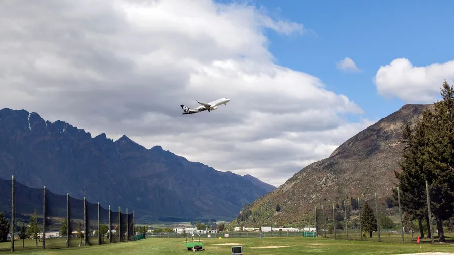 Queenstown, New Zealand: October, 2015: Air New Zealand airbus taking off from Queenstown International Airport. It has been voted the world's most scenic airport approach because of the mountains.