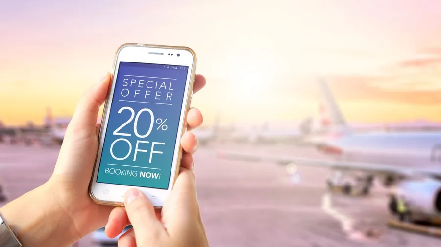 20 Off. Traveler girl in the airport holding a smartphone in her hands with a 20% discount advertising on the screen. Special Offer. Booking now. Marketing, ecommerce, cell phone publicity.