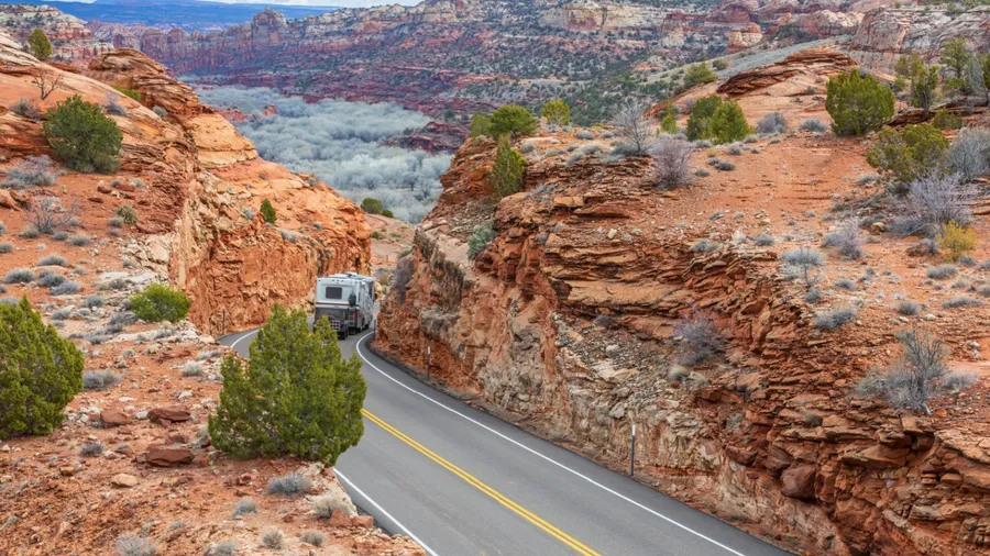 A scenic drive through Utah's Byway 12, surrounded by red rock canyons and desert landscapes, featuring a winding road perfect for road trips and RV adventures.